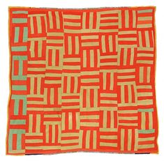 an orange and green quilt with squares on it's sides, in the shape of rectangles