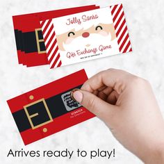 someone is holding up two red and black business cards with santa's face on them