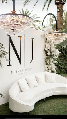 a white couch sitting in front of a sign