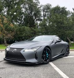 a gray sports car parked in a parking lot