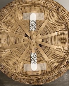 a wicker basket with white tags on it