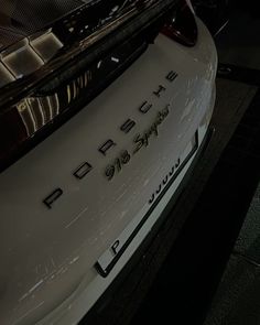 the back end of a white porsche car