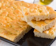 two pieces of bread sitting on top of a black plate