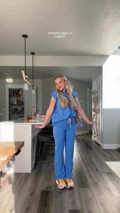 a woman standing in the middle of a living room