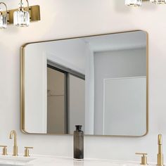 a bathroom with two sinks and a large mirror