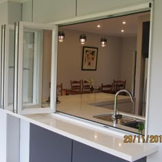 an open kitchen window showing the dining room