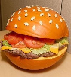 a hamburger with tomatoes, lettuce and cheese