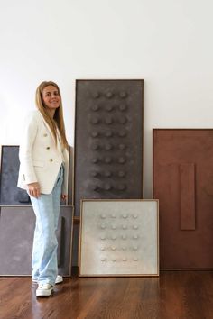 a woman standing next to some art pieces