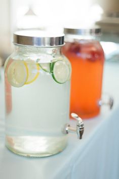 two mason jars filled with water and lemon slices