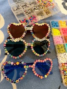 two pairs of sunglasses with colorful beads on them and some other items in the background