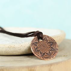 This simple yet stunning mandala necklace is the perfect piece to keep you centered. A mandala is a sacred space, often a circle, which reveals inner truth about you and the world around you. Speak, the universe is listening. ❤ 23mm Copper disc with mandala pattern ❤ 3mm Deer skin lace - choose your length To order yours, choose your options & add it to your cart. Choose your shipping method, and check out. Holistic Jewelry With Adjustable Cord For Meditation, Adjustable Round Spiritual Medallion Necklace, Adjustable Round Medallion Necklace For Spiritual Use, Adjustable Medallion Jewelry For Meditation, Bohemian Bronze Medallion Necklace For Gift, Bohemian Bronze Medallion Necklace As Gift, Adjustable Spiritual Medallion Pendant Necklace, Spiritual Adjustable Copper Necklace, Adjustable Copper Spiritual Necklaces