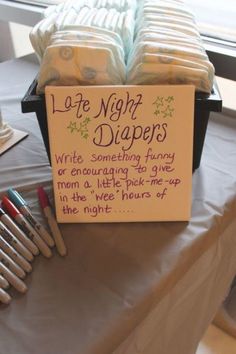 a sign that says late night diapers written on it next to some crayons