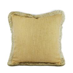 a beige pillow with fringes on the front and back of it, against a white background