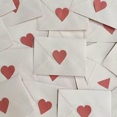 many envelopes with hearts cut out of them