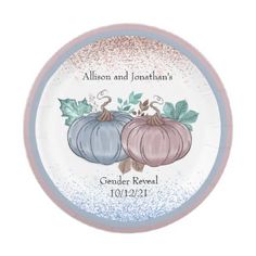 a plate with two pumpkins and leaves on it, in blue and pink colors