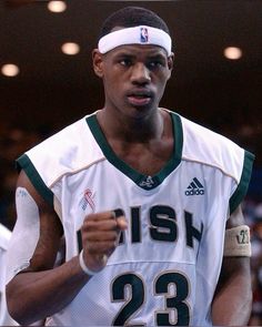 a close up of a basketball player wearing a headband and pointing to the side