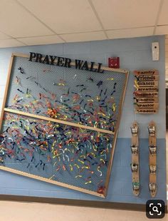 a bulletin board that says prayer wall with confetti sprinkles on it