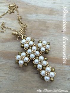 a cross made out of pearls on a wooden table