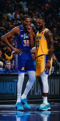 two basketball players standing next to each other