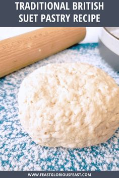 a ball of dough sitting on top of a blue towel next to a rolling pin