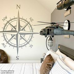 a bedroom with a bed and a helicopter on the wall