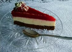 a piece of cheesecake on a glass plate with a spoon