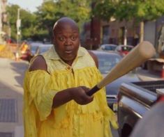 a man holding a baseball bat on the street