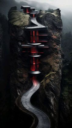 a long winding road with red lights going up the side of it in the mountains