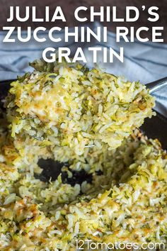 a close up of food in a pan on a table with the words julia child's zucchini rice gratin