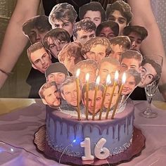 the birthday cake is decorated with many photos and candles