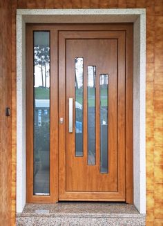 a close up of a wooden door with glass panels on the front and side doors