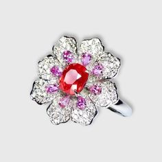 !!WOW!!  A STUNNING JEDI SPINEL!  Featured in a Diamond Couture Flower Ring. Bright orange-pink spinel measures 1.03ct, smaller, pear-shaped, light-violet tourmalines and diamond petals, all set in 18K white gold.  Size 7. 1.03ct natural Jedi Spinel and natural white South African diamonds, bright color, clean-crystal, good clarity. Shape: Oval. Cut: Excellent. Internationally certified natural Spinel, comes with International Jewelry Appraisal Certificate. Designer: unknown. Fine Jewelry Flower-shaped Multi-stone Rings, Fine Jewelry Flower Cluster Ring With Gemstone, Diamond Multi-stone Flower Ring, Flower Shaped Diamond Ring With Multi-stones, Exquisite Flower Shaped Gemstone Rings, White Gold Ruby Multi-stone Diamond Ring, White Gold Ruby Diamond Ring With Multi-stone, Diamond Flower Ring With Gemstone, Luxury Flower-shaped Rings With Center Stone