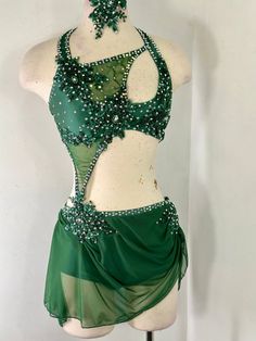 a woman's green belly dance costume on a mannequin headdress