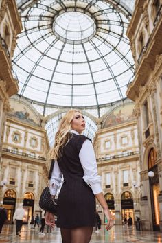 a woman standing in the middle of a building