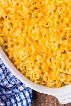 macaroni and cheese in a white casserole dish on a wooden table