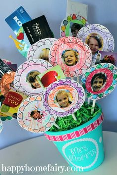 a flower pot filled with lots of different pictures on top of cards and magnets