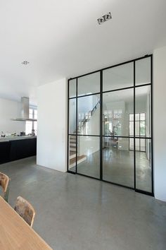 an open kitchen and dining room with glass doors