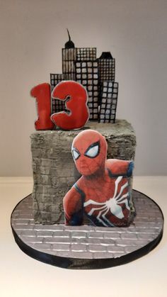 a spiderman birthday cake with the number thirteen on it