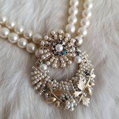 "This is a vintage statement necklace from the 1950's-1960's. The necklace is made from two white pearl tone bead strands. The pendant is also the clasp of the necklace and is a white pearl tone and AB crystal statement piece. The back is a gold tone metal with the Japan signature. The necklace has a few areas of wear on the back from age. The necklace is in great condition. Measurements: Strand Length: 17\" | Pendant Length: 2.25\" | Pendant Width: 1.75\" Unless otherwise stated all vintage ite Vintage Pearl Necklace With Pendant, Vintage Pearl Charm Jewelry For Anniversary, Vintage Jewelry With Pearl Charm For Anniversary, Antique White Pearl Necklaces, Vintage Pearl Embellished Necklace As Gift, Vintage Pearl Necklace As Gift, Vintage Pearl Embellished Necklace For Gift, Vintage Pearl White Necklaces With Round Beads, Vintage Pearl White Round Bead Necklaces