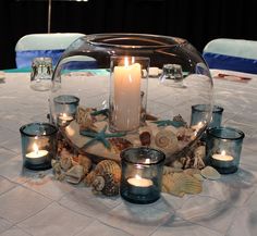 a table with candles and seashells on it