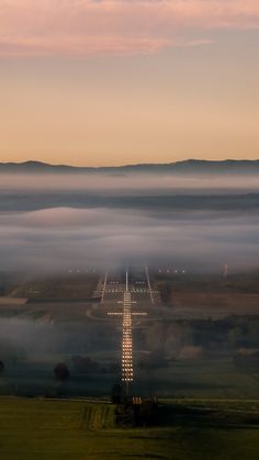 an airplane is flying over the clouds in the sky