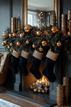 christmas stockings hanging from a mantle with gold and silver decorations on it, next to a fireplace