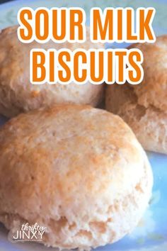 three biscuits on a plate with the words sour milk biscuits above them and below it