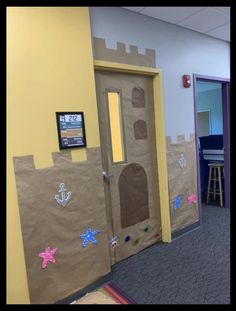 the door to an office is decorated with paper and sandcastles on it's sides