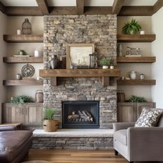 a living room filled with furniture and a fire place in front of a stone fireplace