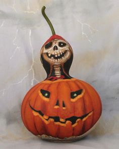 a carved pumpkin with a jack - o'- lantern on the top and an evil face