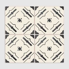 four black and white tiles with geometric designs