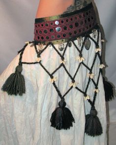 a woman's belly belt with tassels and beads on the bottom part