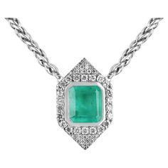 Enthrall in this majestic natural Colombian emerald necklace. The center stone features a remarkable 8.76-carat, natural Colombian emerald that showcases a vivacious medium green color with a minimal yellowish-green hue. The stone's size followed along by its beautiful color, saturation, hue, etc is rare to find; making this piece so much more unique and special. Accenting the large center stone are 2.0 (mm) brilliant round cut diamonds creating the perfect halo, and more petite round diamonds cluster; accenting the top and bottom as well. This sleek design is crafted in 14K white gold, with an 18.5-inch wheat white gold chain attached. Setting Style: Bezel/Prong/Pave Setting Material: 14K White Gold Setting Weight: 19.8 Grams Main Stone: Emerald Shape: Emerald Cut Weight: 8.76-Carats Clar White Gold Chain, White Gold Chains, Stone Feature, Colombian Emeralds, Emerald Necklace, Emerald Cut Diamonds, Diamond Halo, Diamond Cluster, Round Cut Diamond