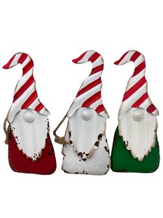 three santa hats with candy canes hanging from the top one is red, white and green